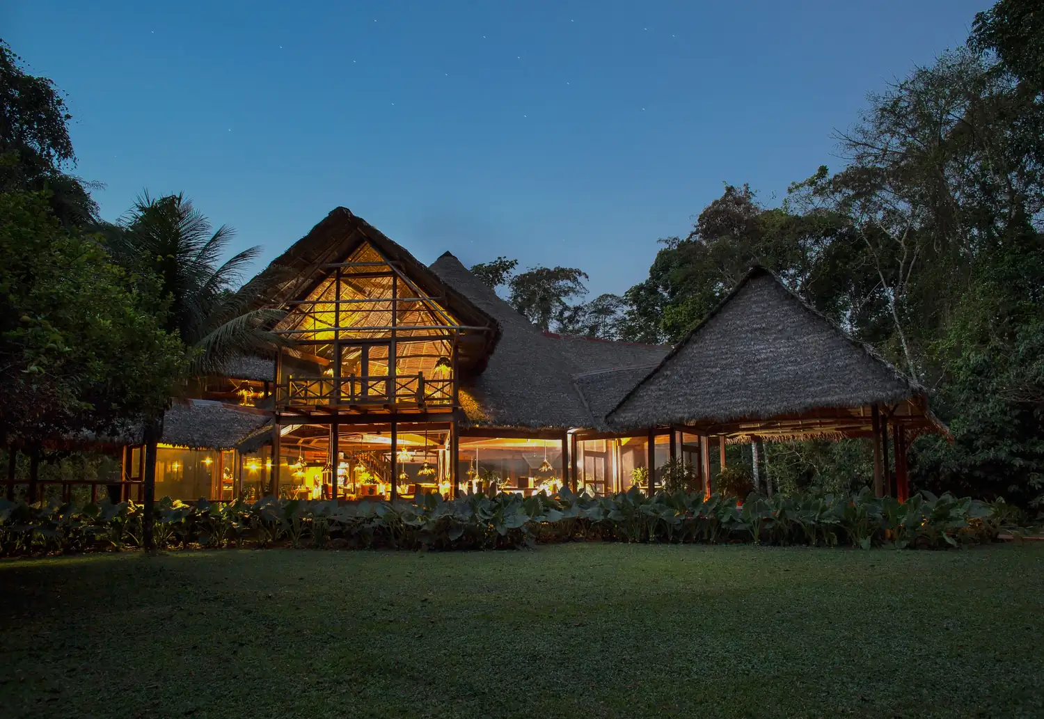 The main house of Inkaterra Reserva Amazónica at dusk