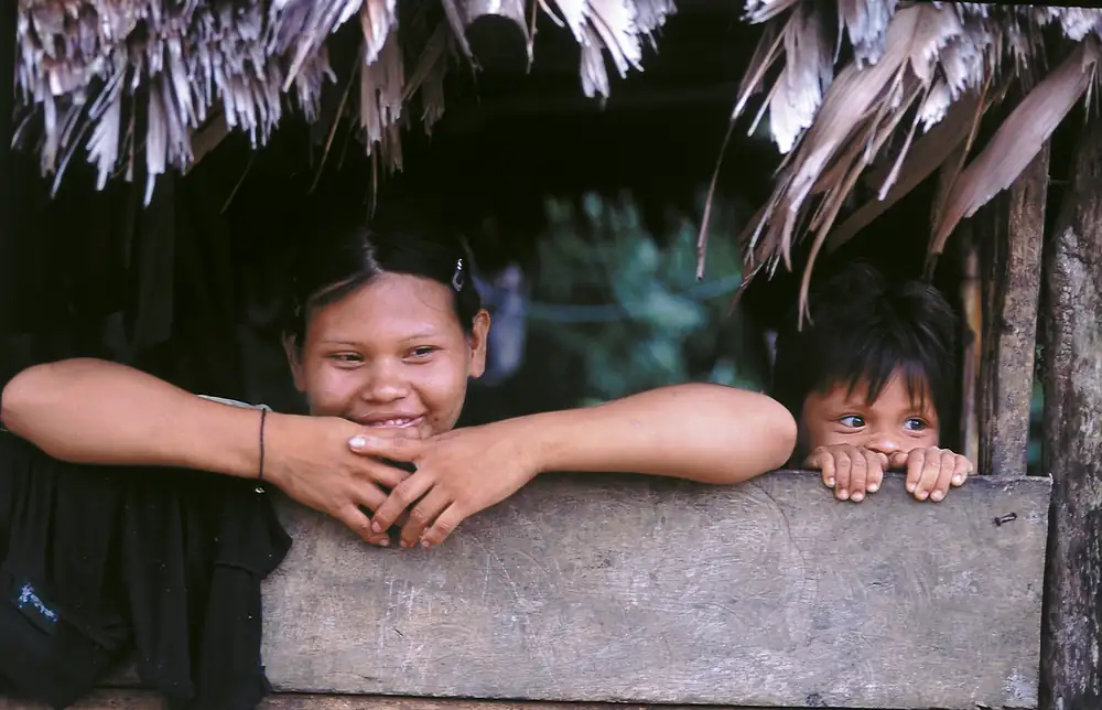 Members of an Ese’Eja family looking out from a window
